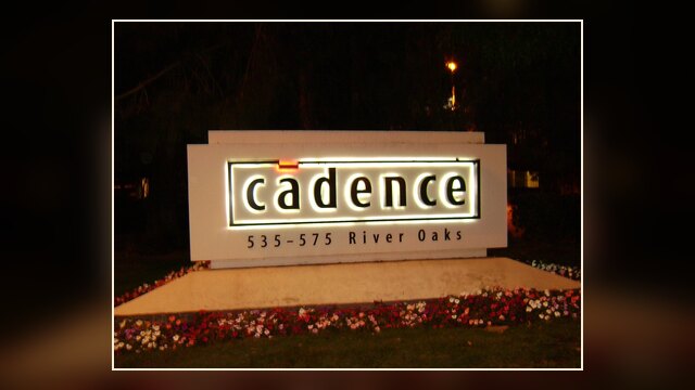 Cadence Design Systems corporate logo sign on Building 1 at the San Jose campus at night.