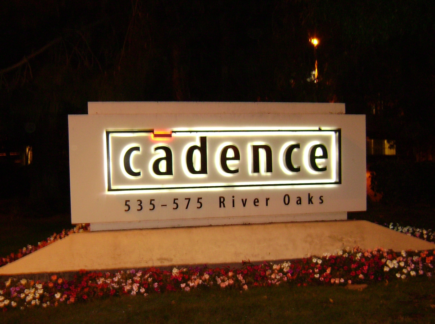Cadence Design Systems corporate logo sign on Building 1 at the San Jose campus at night.