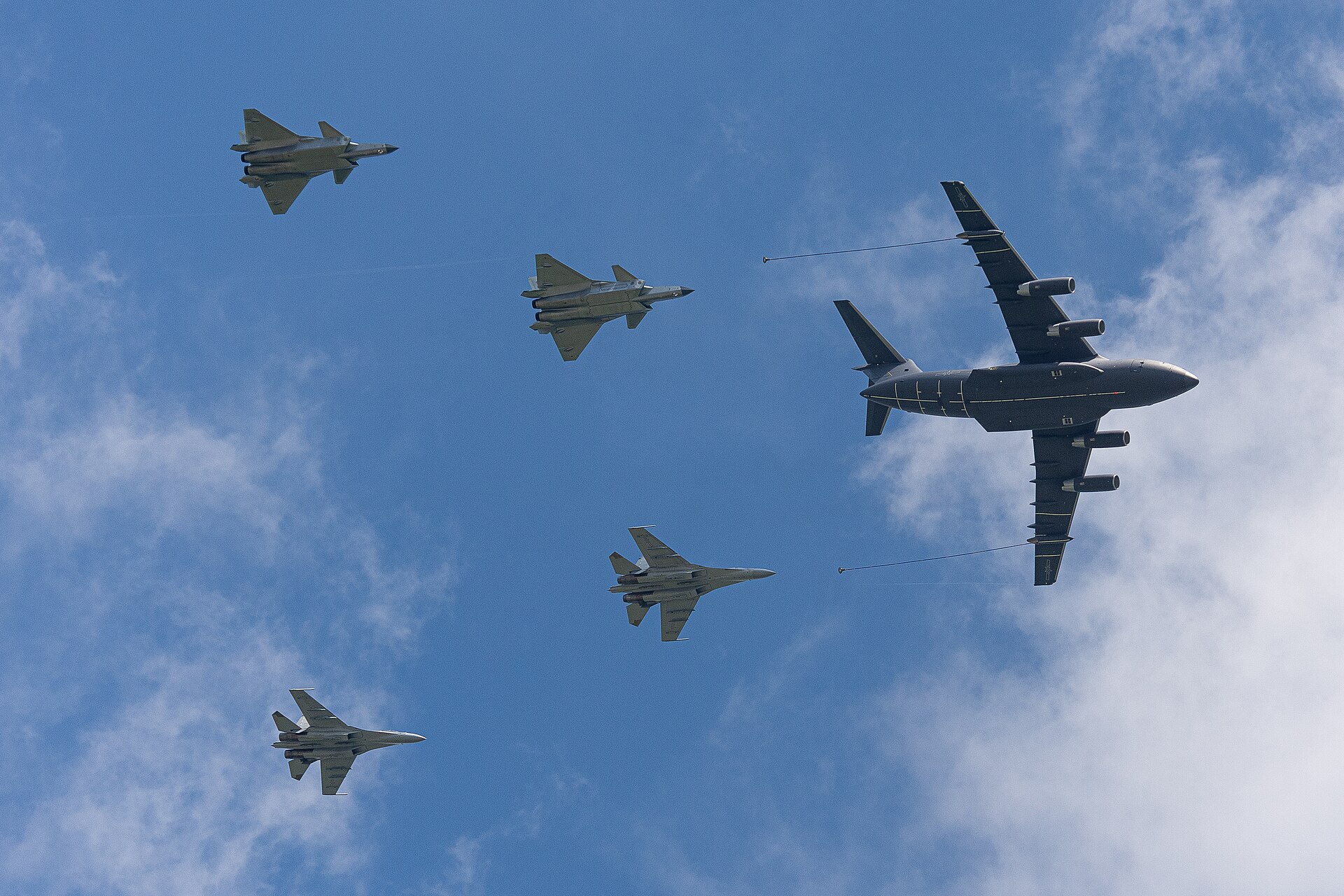 Chinese J-16 fighter in formation with other aircraft during aerial refueling.
