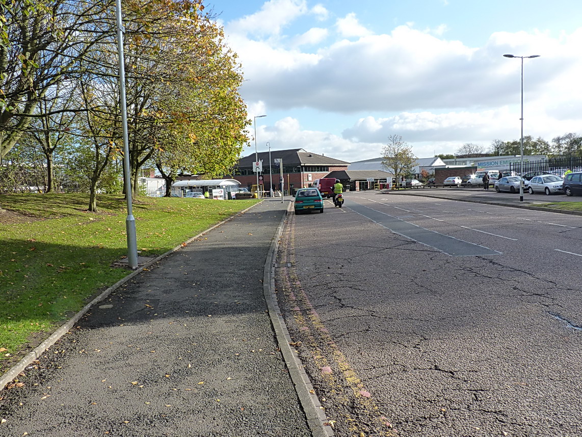 Entrance and signage at the Jaguar Land Rover works off Lode Lane, showing the factory entrance and perimeter.