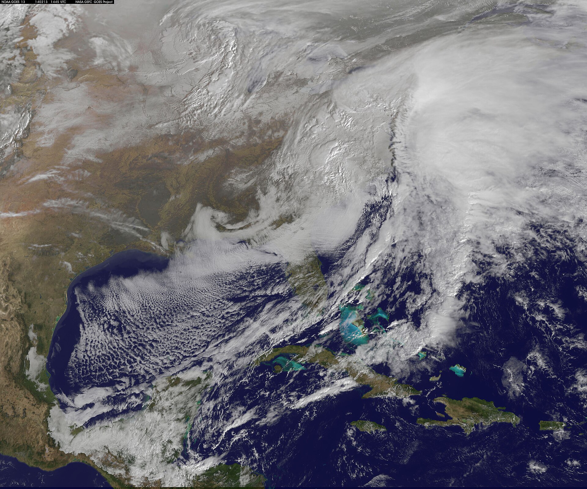 Satellite view showing extensive cloud cover and a large storm system stretching from the Mid-Atlantic into New England, illustrating the multiday storm impacting the Northeast.