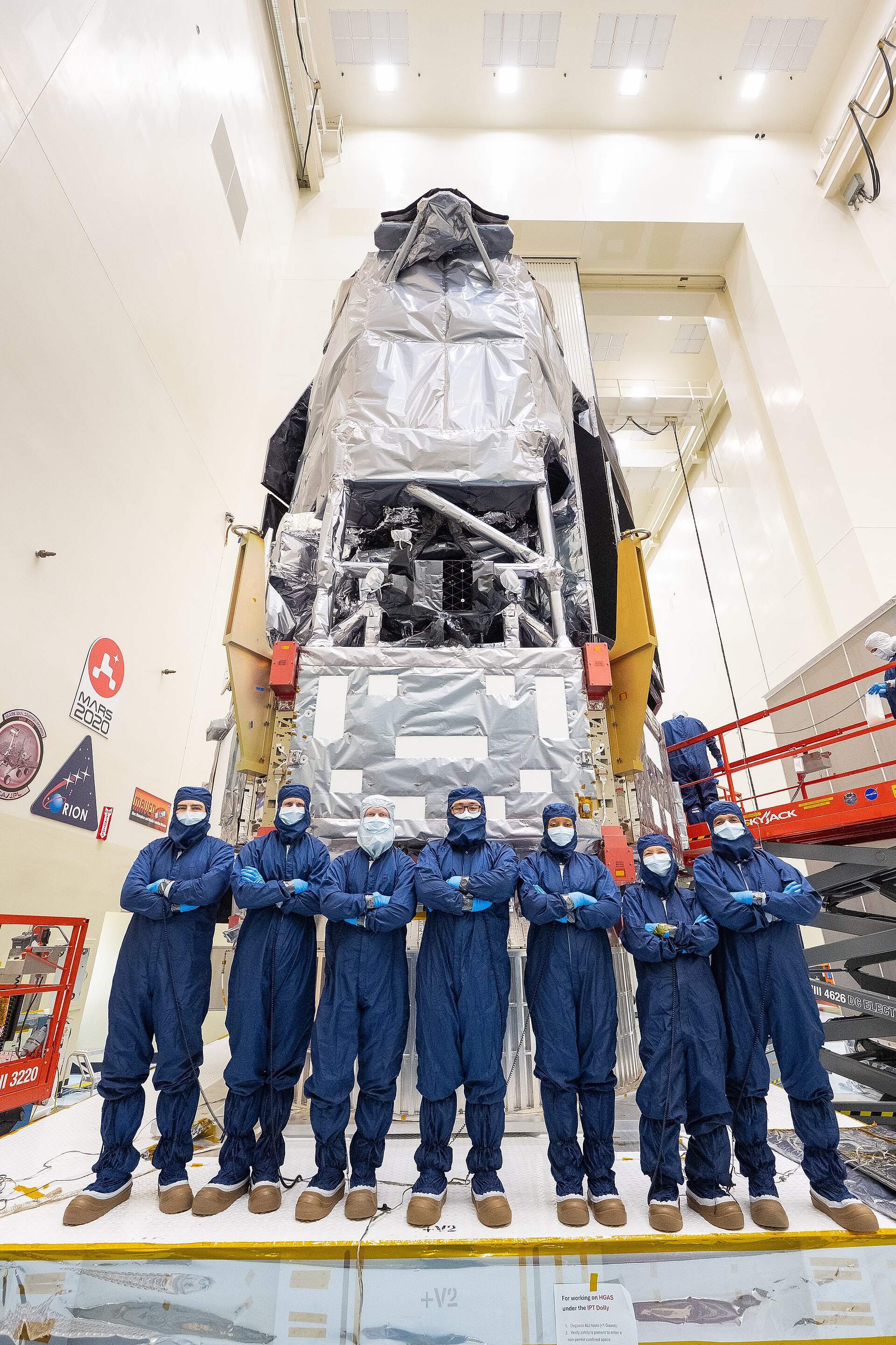 Technicians and engineers inside NASA’s Kennedy Space Center Payload Hazardous Servicing Facility during integration of the Nancy Grace Roman Space Telescope, shown after closeout of the observatory’s Coronagraph Instrument test connector panel (photo credit: KSC-20260708-PH-JMT02_0001).
